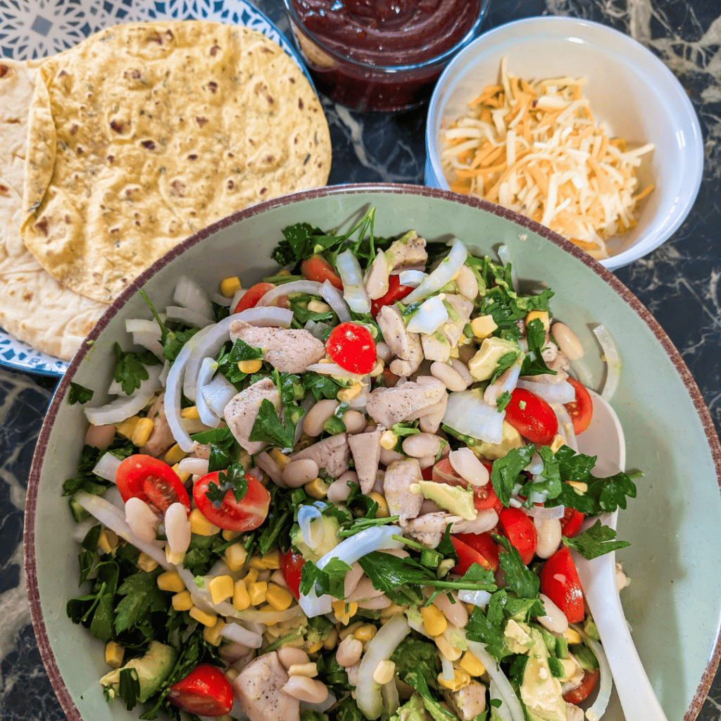 BBQ Chicken Wraps with fresh vegetables and cheese on a plate.
