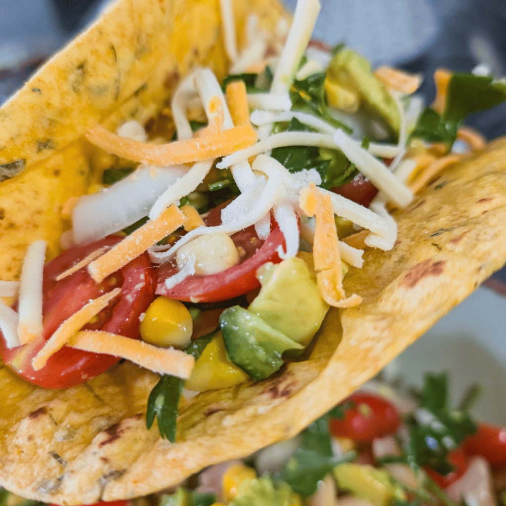 Delicious BBQ chicken wraps filled with fresh vegetables and cheese, perfect for a quick and tasty m.