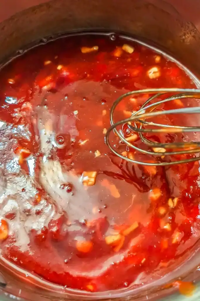 mixing ketchup and sriracha to bbq sauce