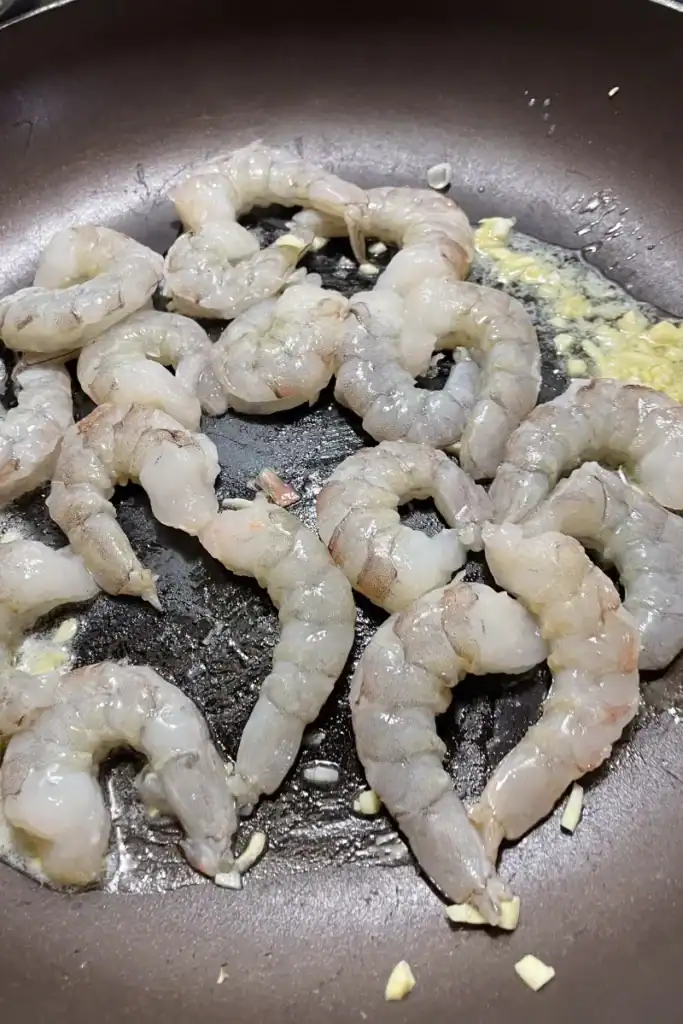 raw shrimp added to fry pan