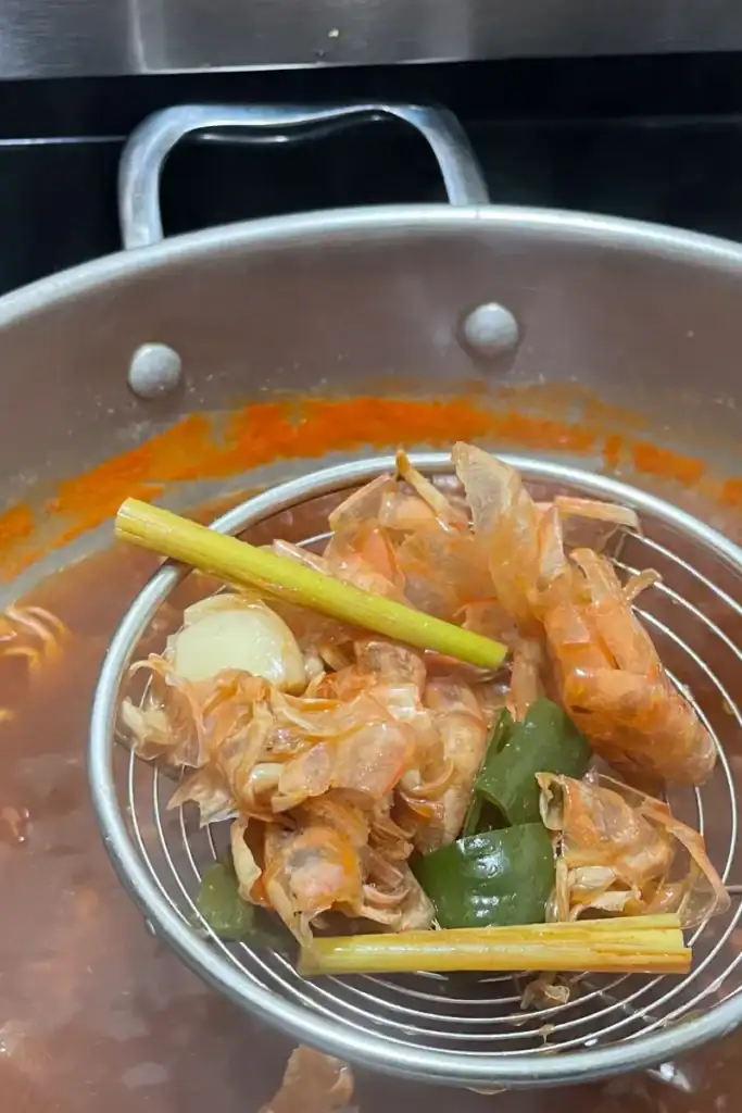 removing shell and aromatics from shrimp stock