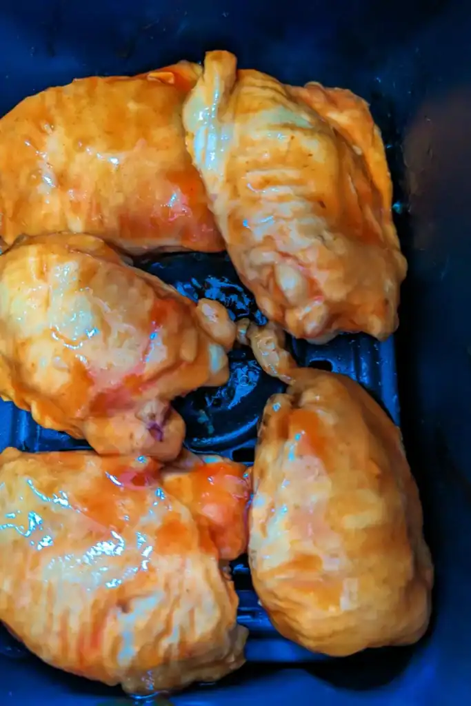 returning sauced chicken thighs to air fryer basket