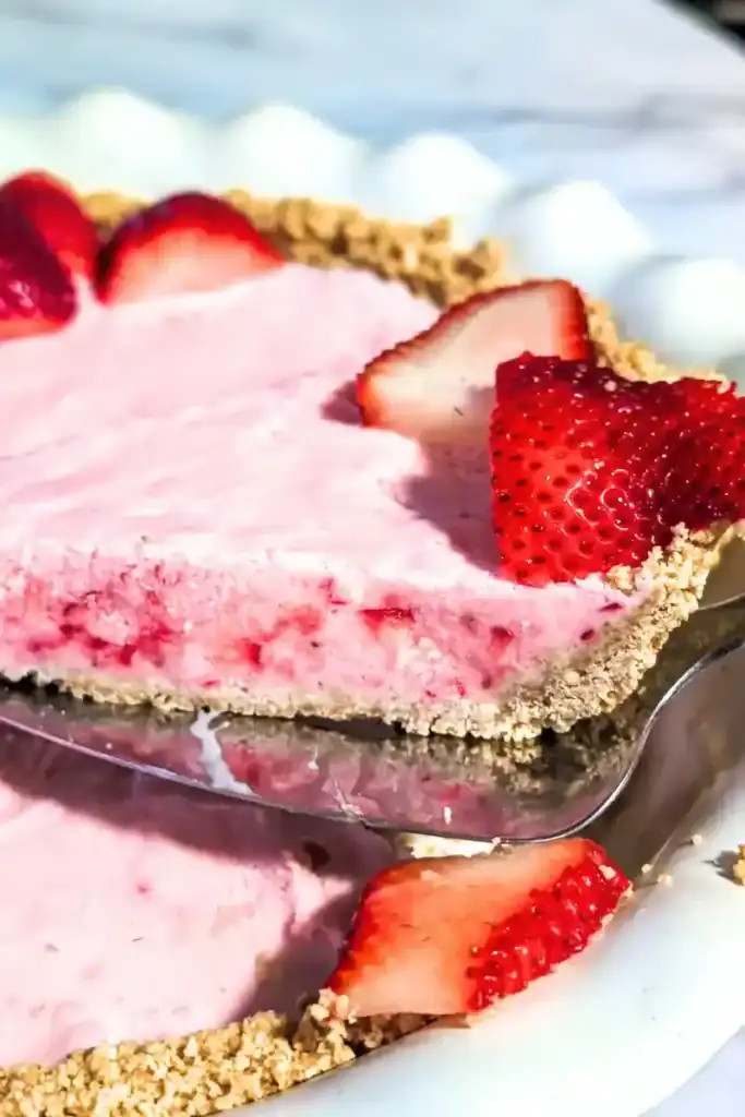 cutting into the frozen strawberry pie