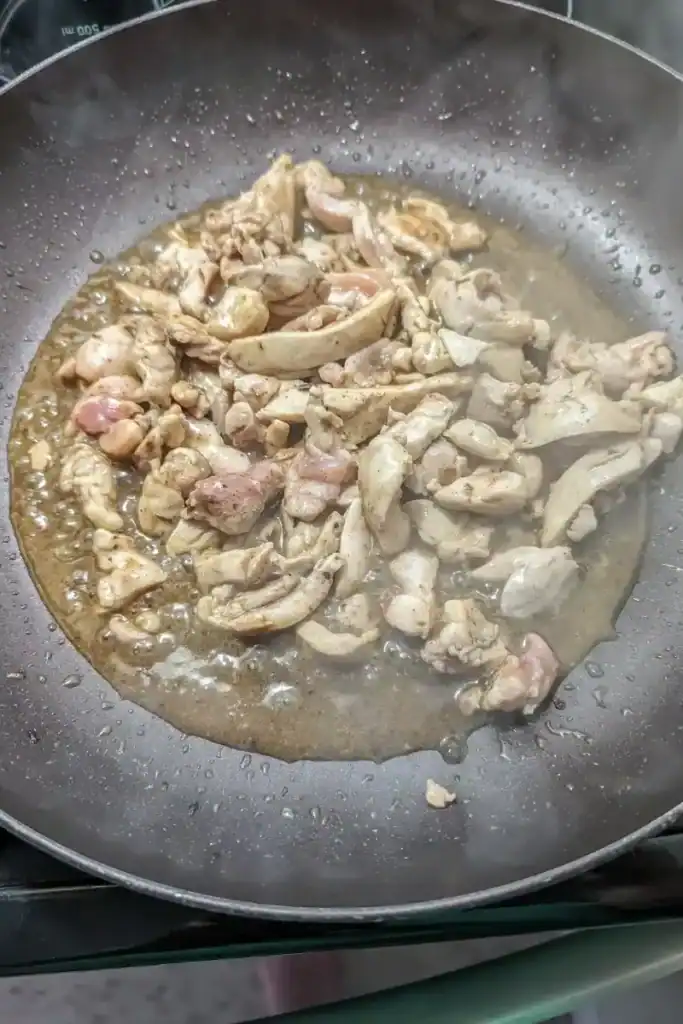 adding the jerk sauce to the chicken and cooking
