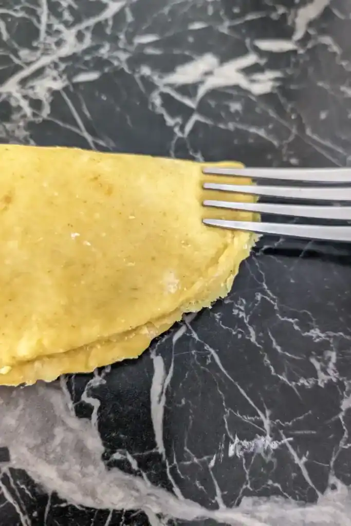 Using the forks tines to crimp the edge of the patty