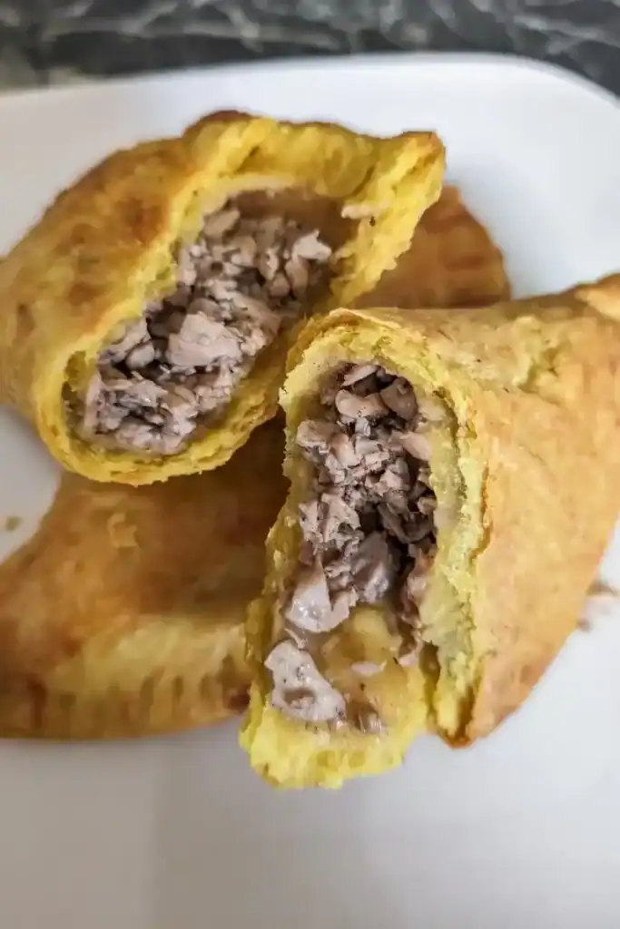 fully cooked Jerk chicken Jamaican patties opened