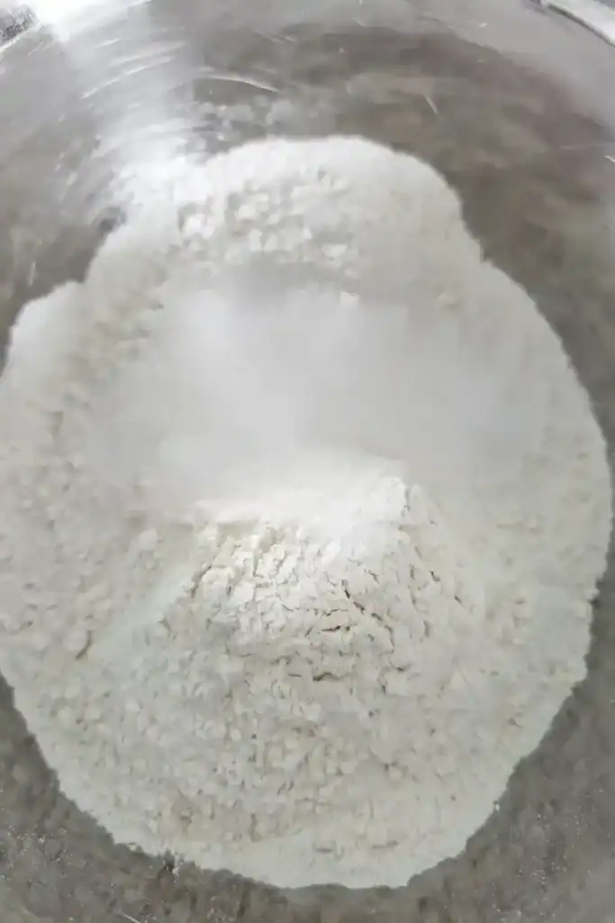 adding baking powder to flour