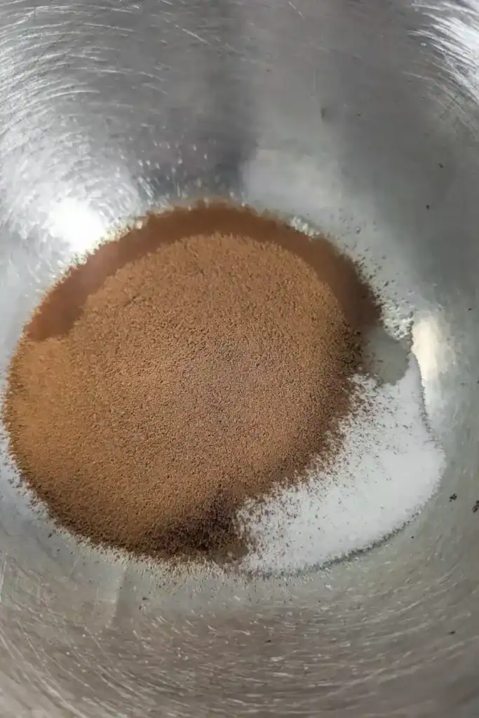 espresso powder added to egg white and sugar in bowl