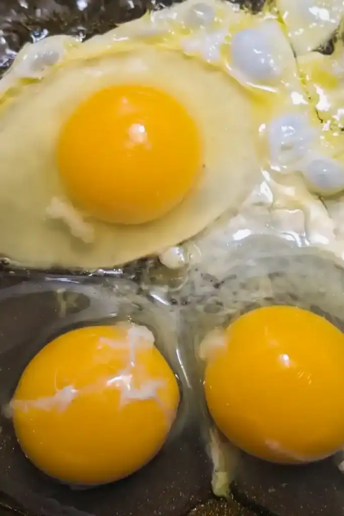 three frying eggs to scramble