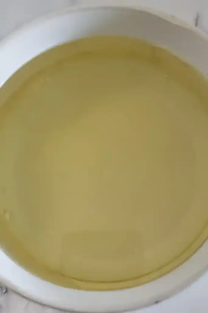 adding vegetable oil for salad dressing