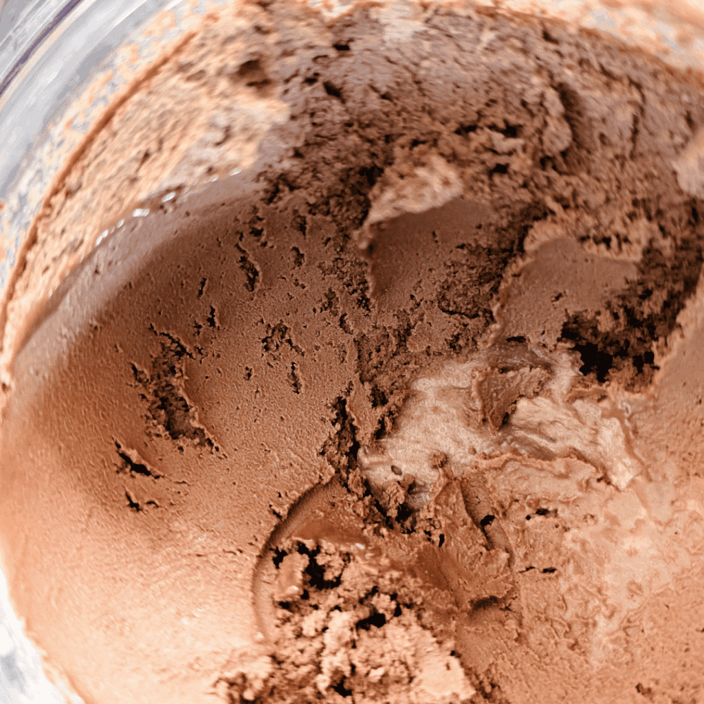 Close-up of chocolate powder mix in a bowl, ideal for baking and cooking recipes.