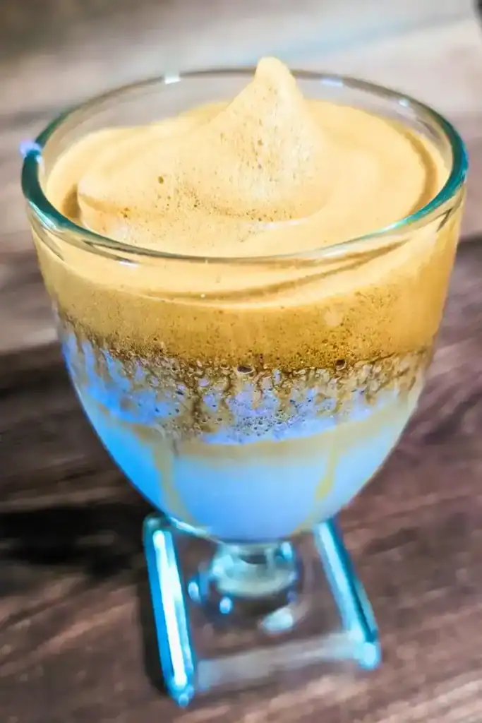 the Dalgona taro latte in a wide glass from the top angled