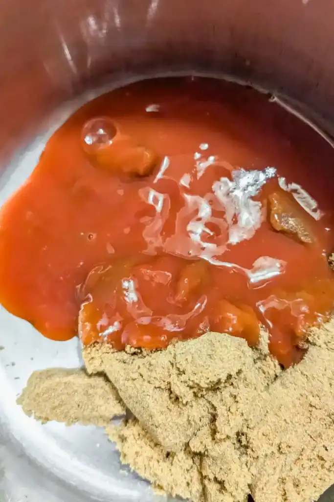 adding ketchup and tomato paste to saucepan for bbq sauce