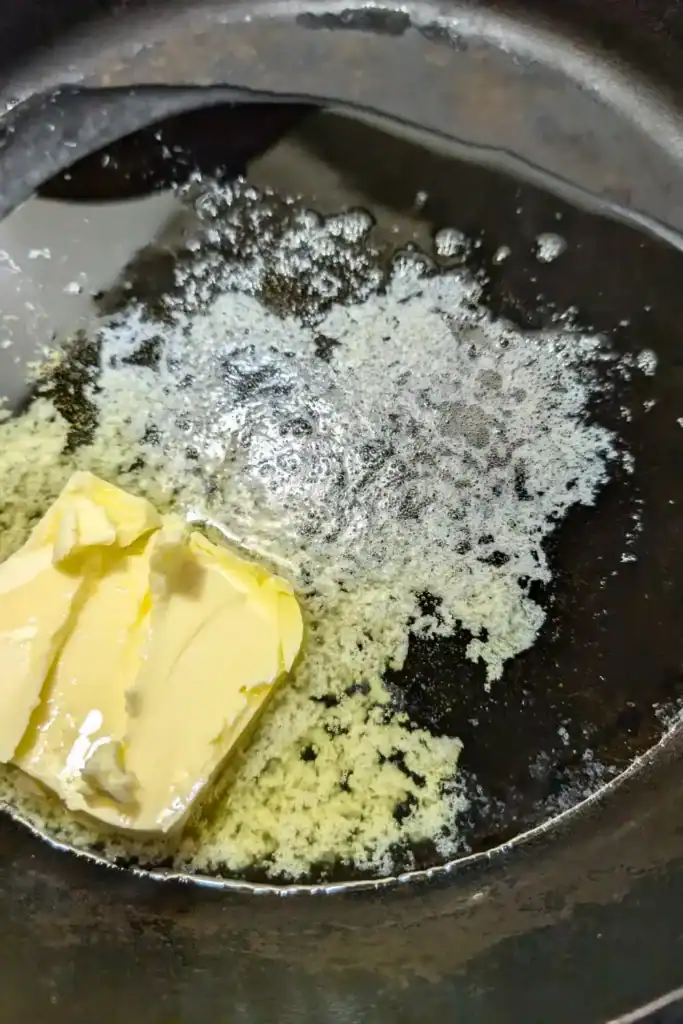 salted butter and olive oil heating in cast iron skillet