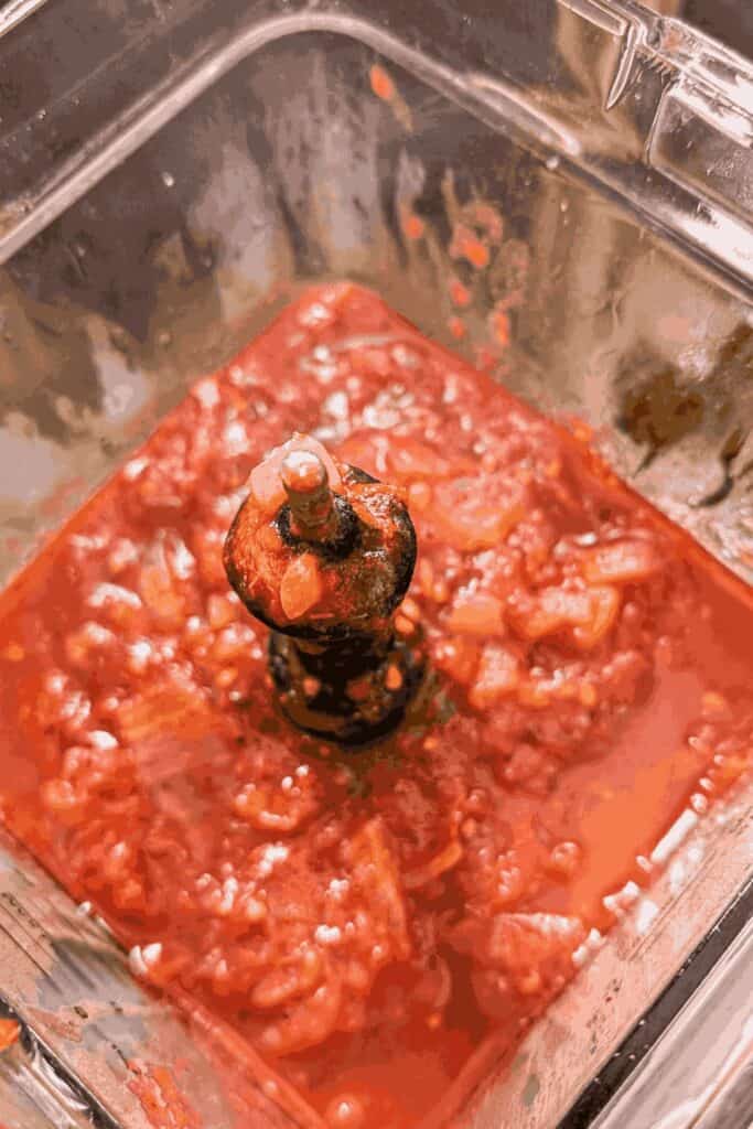 red sauce cooled in blender lid off top down view