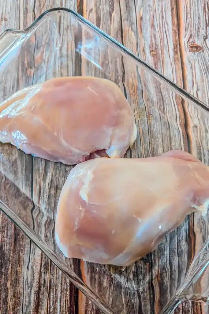 two boneless skinless turkey breast in glass baking dish