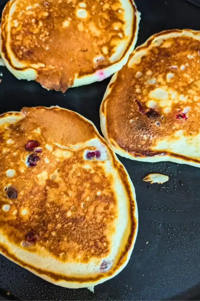 cooking the pancakes on a crepe griddle