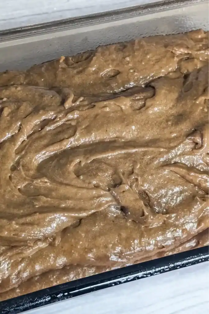 the gingerbread batter in the prepared glass loaf pan