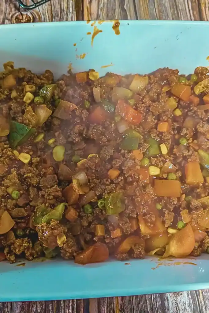 the meat mixture in deep casserole dish