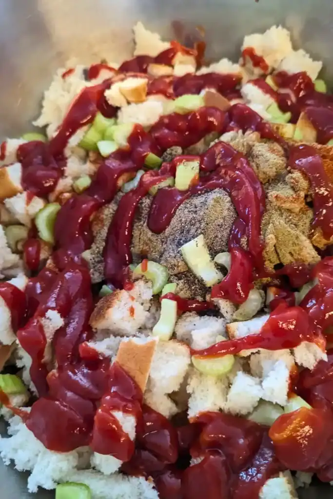 ketchup added to stuffing mixture in bowl