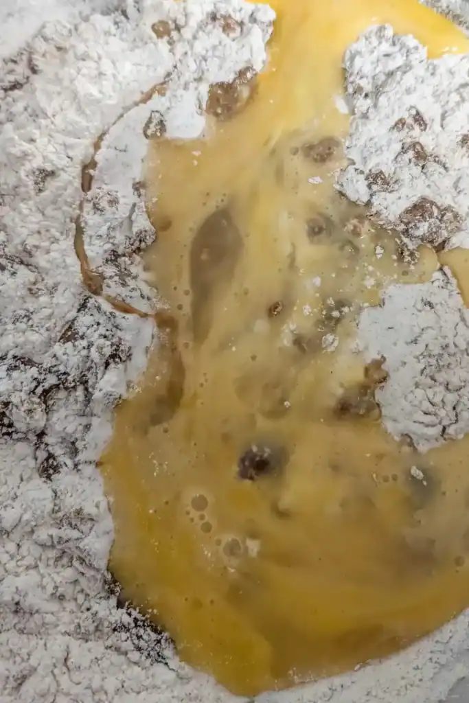 adding beaten eggs to the gingerbread batter