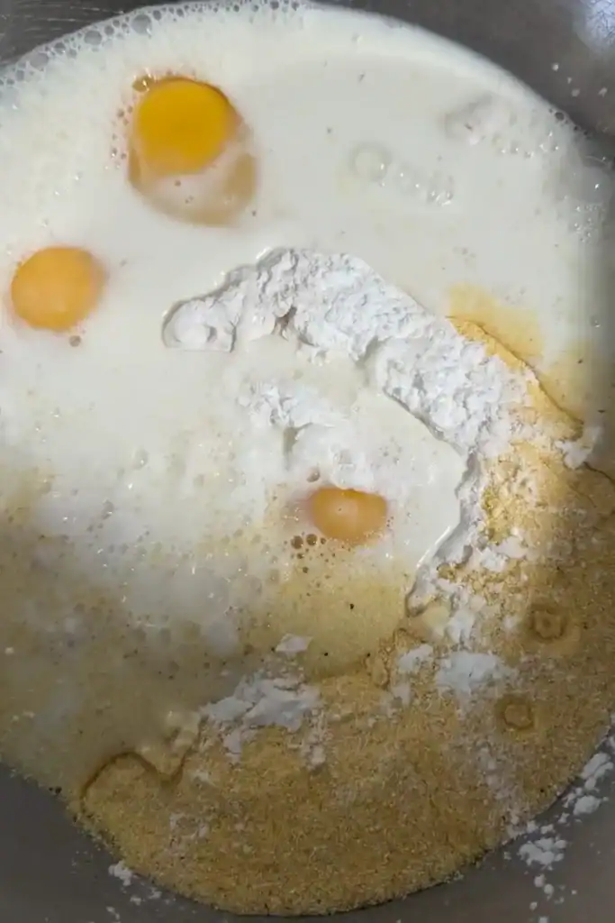 adding milk to one bowl cornbread batter mixture