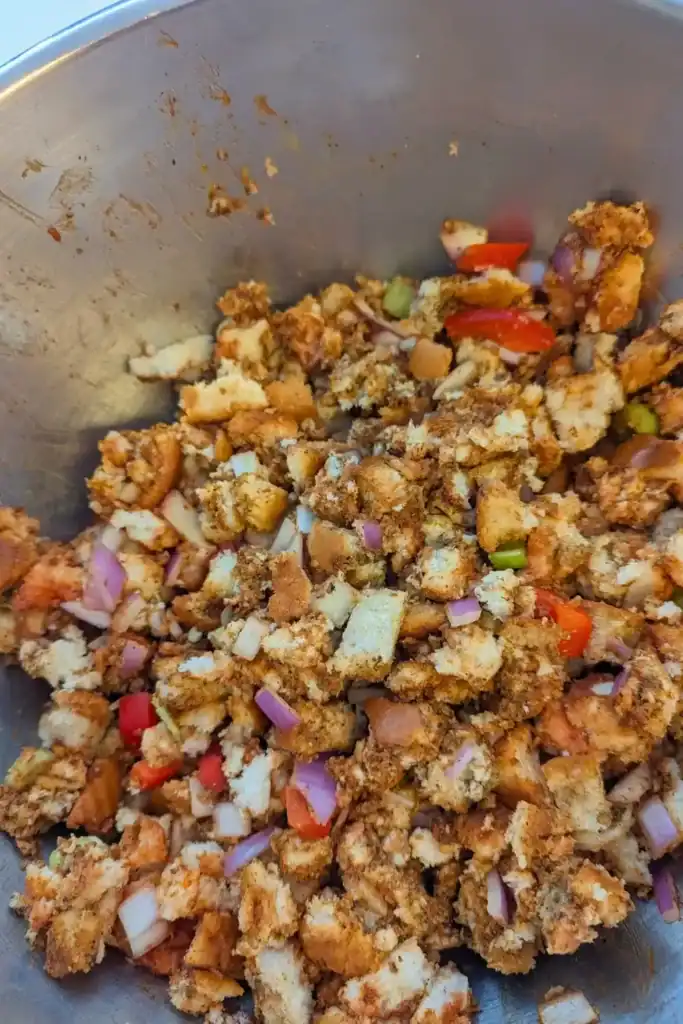 the bread stuffing mixture mixed in stainless steel bowl