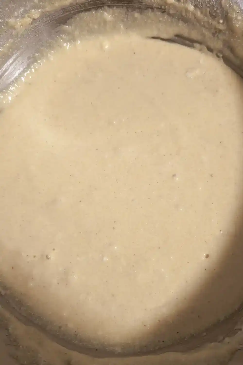 the cornbread batter mixture resting in stainless steel bowl