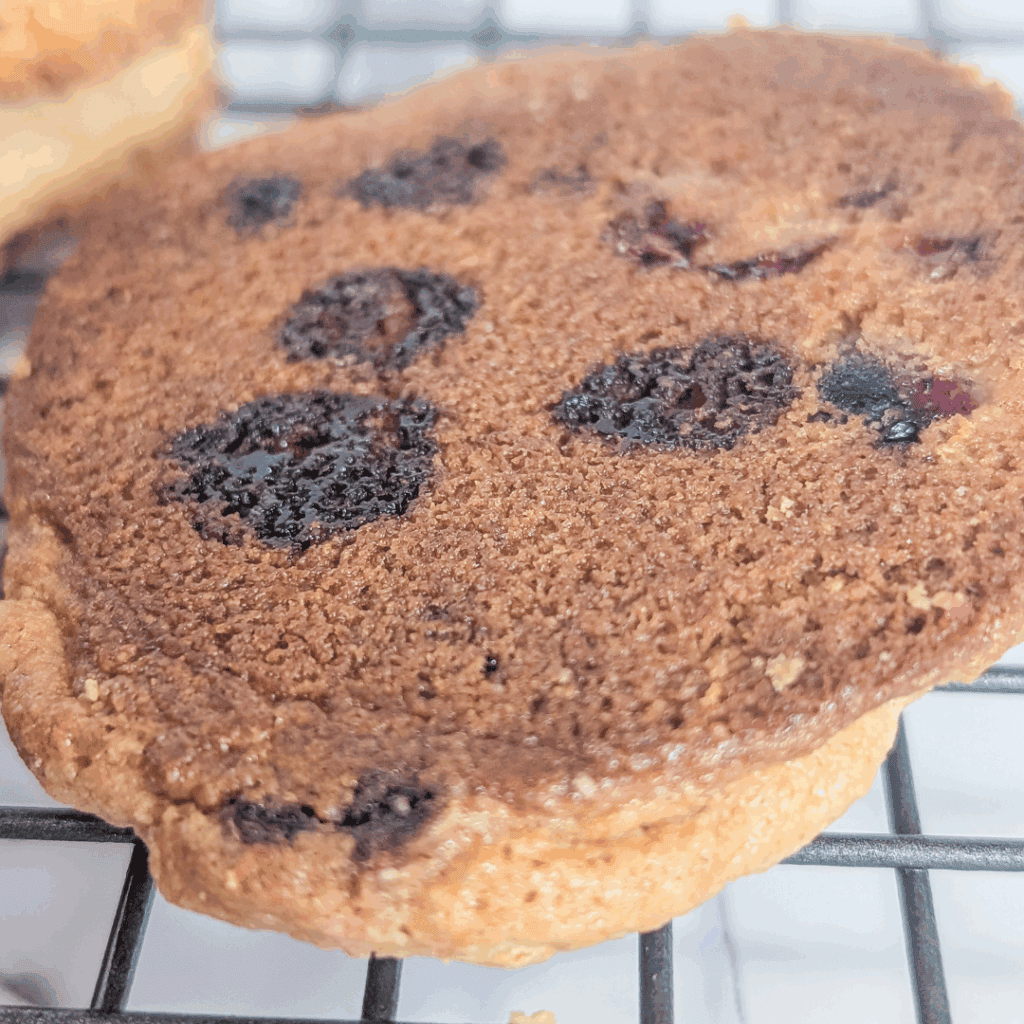 Freshly baked chocolate chip cookie with crispy edges and melty chocolate chips. Perfect for snacking or dessert.