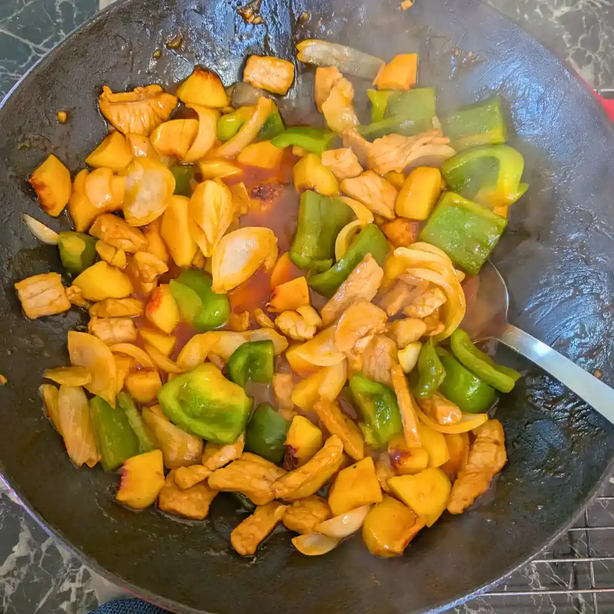 featured image of the sweet and sour pork stir fry in wok cooking