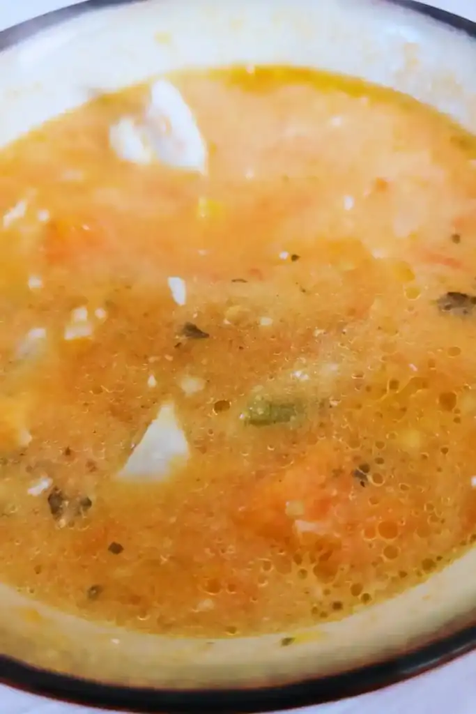 mixing the dollop of sour cream into the soup