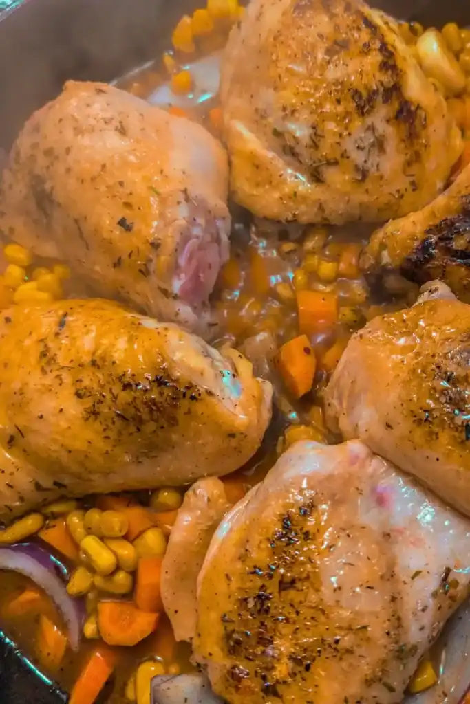 adding the chicken broth and the seared chicken thighs on top of the veggies