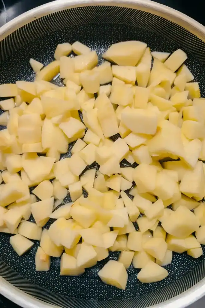 apple pieces in heavy bottomed frying pan