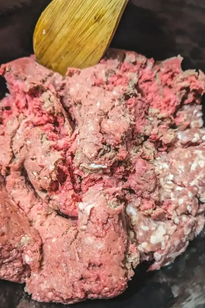adding ground beef and pork to dutch oven