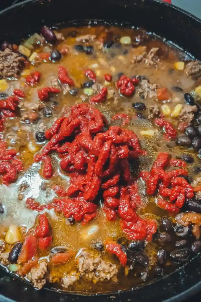 adding in the spices and tomato paste