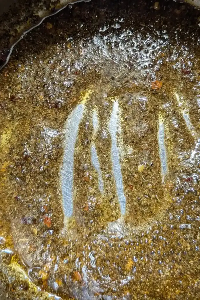 blooming the spices in oil in saucepan