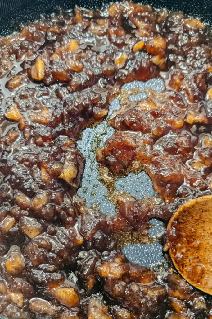 stirring the reducing apple butter