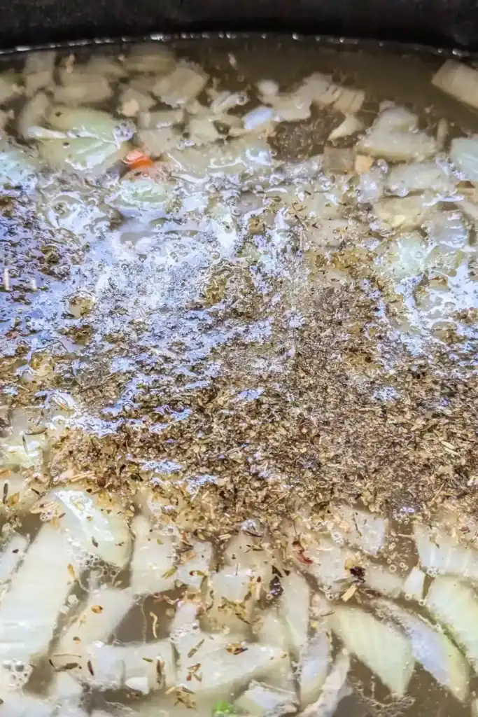 adding herbs to turkey soup