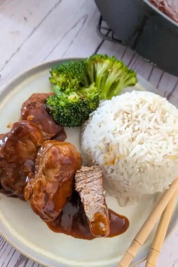 inside the pork medallions with rice and broccoli on plate