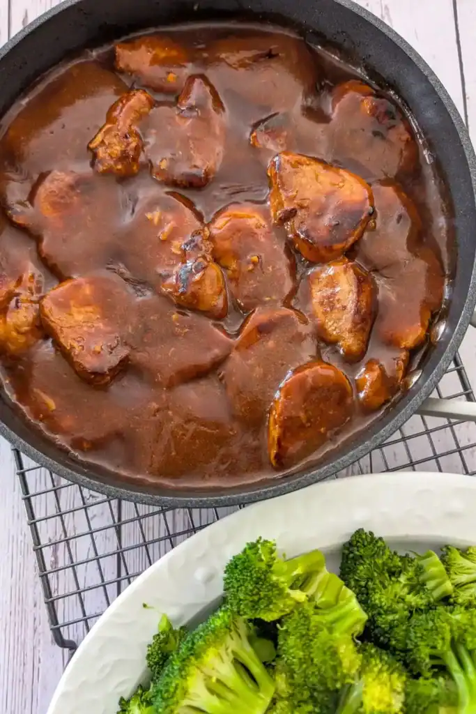 serving medallions with steamed broccoli on wire rack