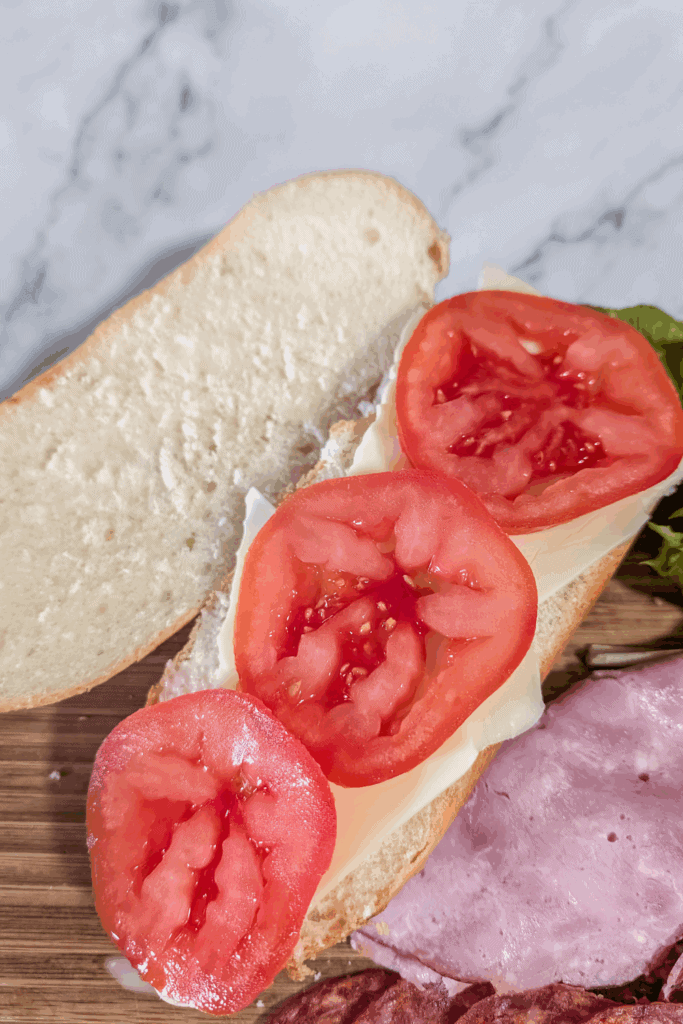 add tomato on cheese to open sub bun