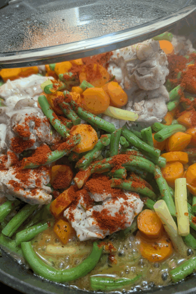 adding paprika to chicken thigh in pan