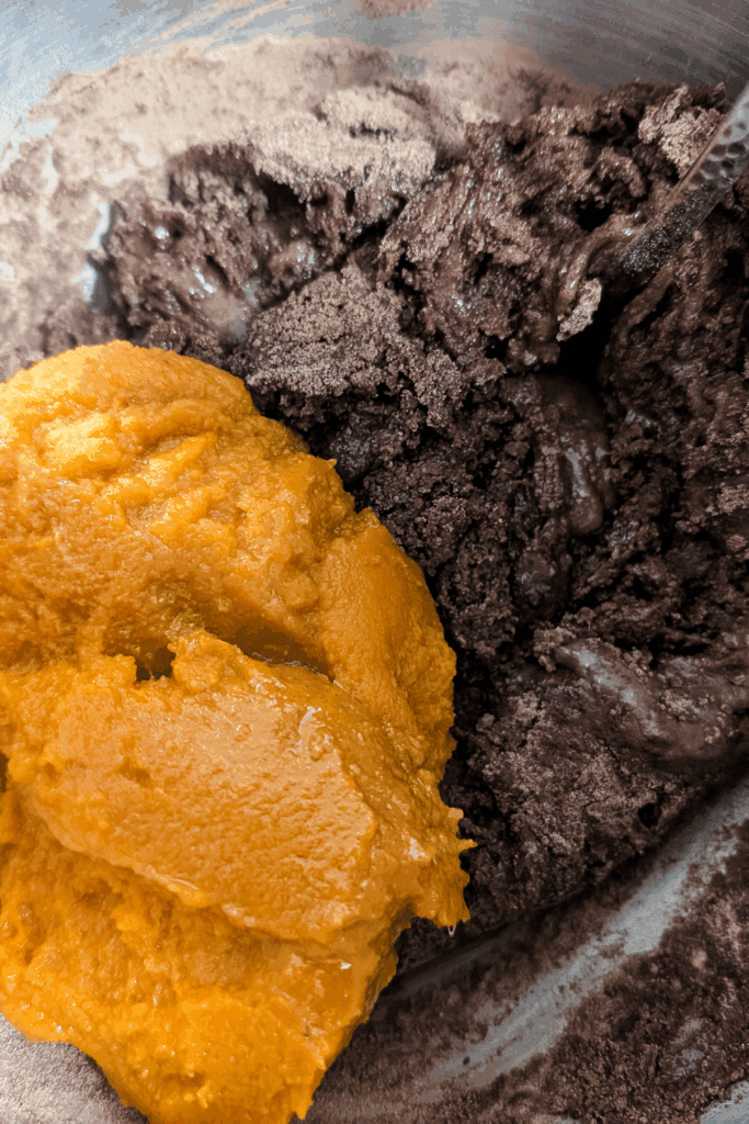 adding pumpkin to mixture