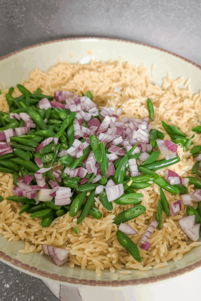 adding red onion to the salad bowl