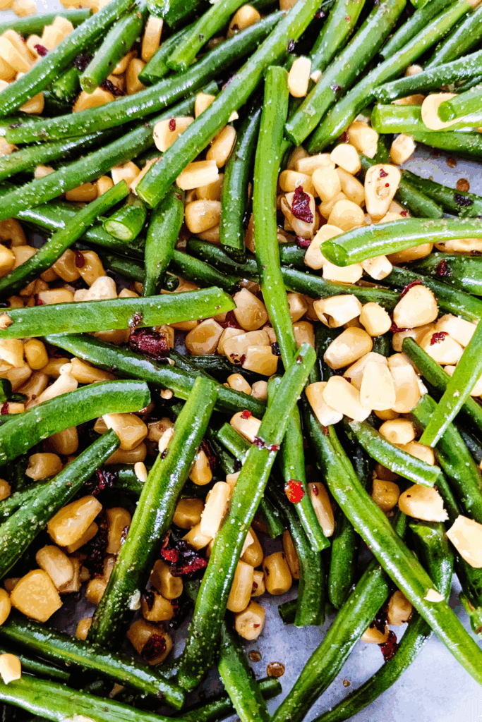 Green beans and corn mixed with red pepper flakes.