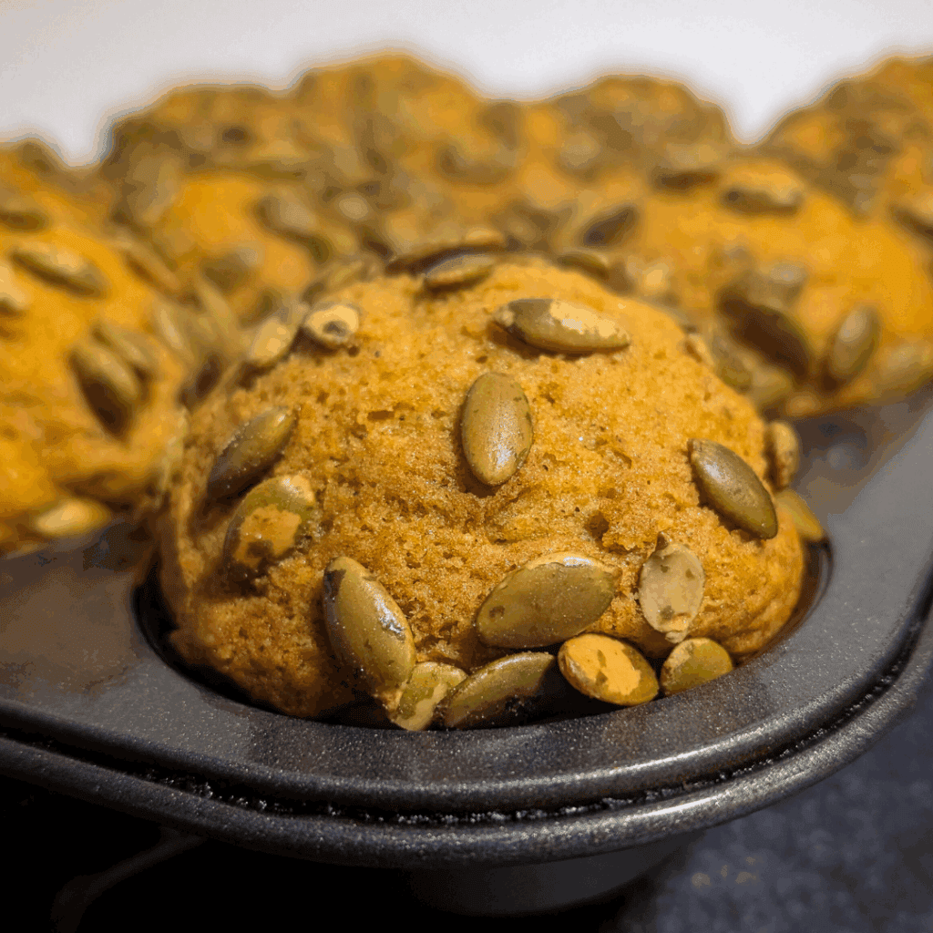 Sweet pumpkin cookies topped with pumpkin seeds for fall baking. Perfect for holidays and cozy family treats.