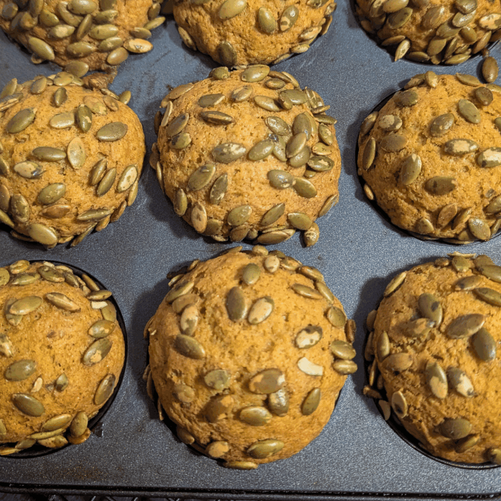 Cookies with pumpkin seeds on top.