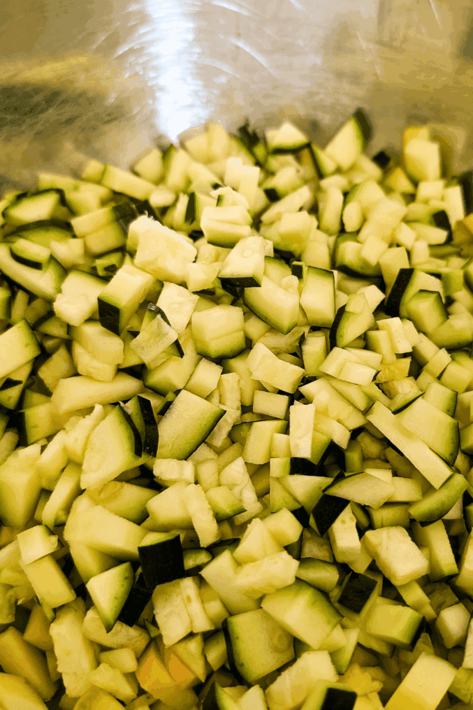 Diced zucchini in a mixing bowl ready for cooking or recipes.