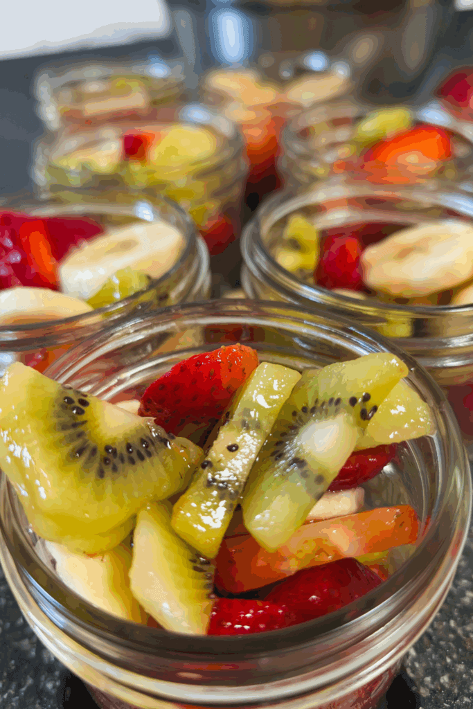 Fresh fruit salads in small jars for healthy snack ideas.