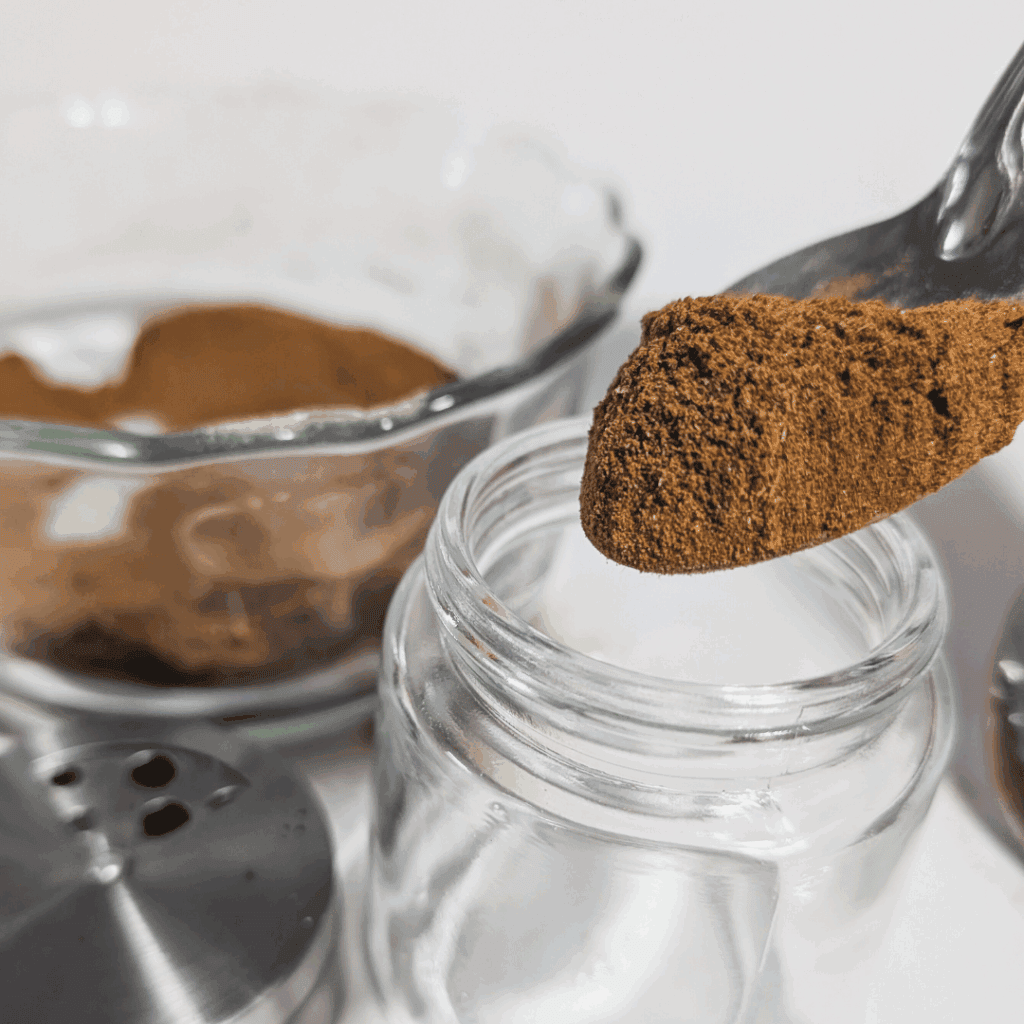 Finely ground cinnamon sticks and spices in glass jars for cooking and baking.